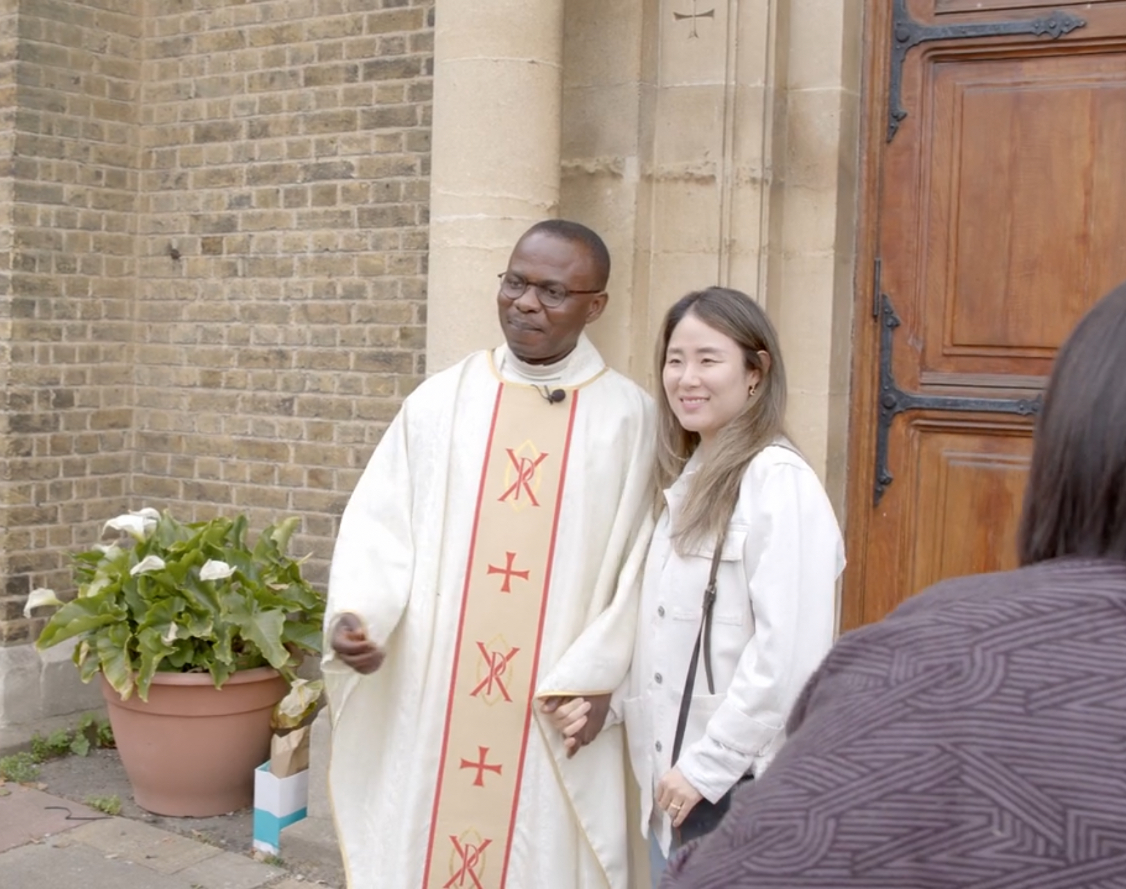 Fr Hyacinth with parishioner